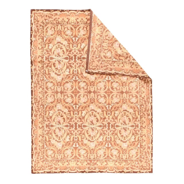 This well-drawn rug shows the influence of William Morris in its two echelon pattern of three open barbed leaf, rose swag...