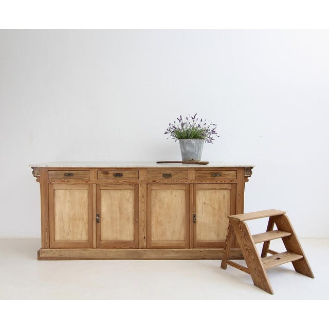 Large French shop counter from around 1900. Solidly crafted from pitch pine with a marble top. Refurbished to a ready-to-...