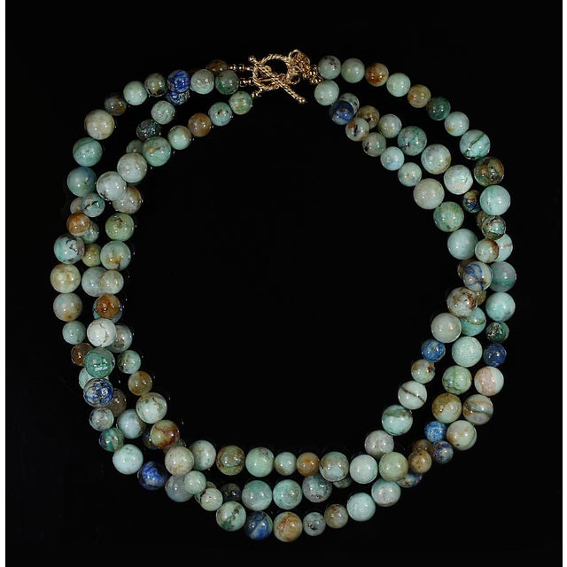This 17‑inch three‑strand chrysocolla and azurite necklace becomes a standout piece the moment you put it on. The...