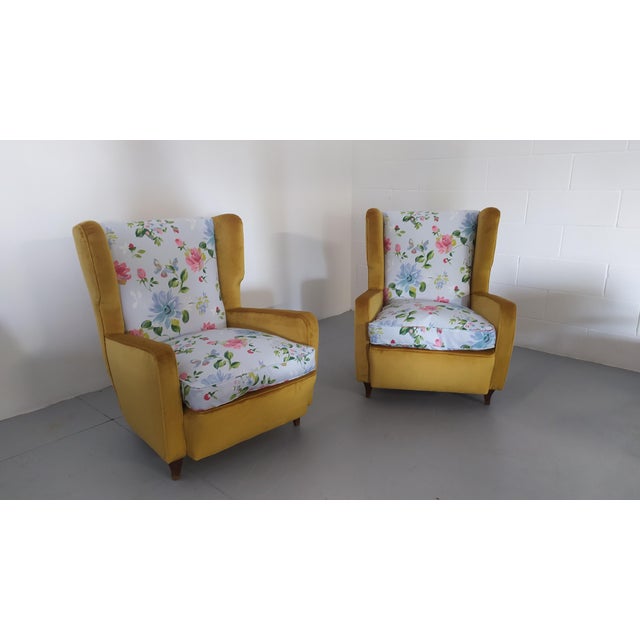 Pair of yellow velvet bergère armchairs with floral satin interior. The shape of the backrest and armrests reveals a...