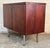 Efficiently-sized two-door storage cabinet. Composed of rich rosewood veneer, brass hairpin legs, & brass handles, the...