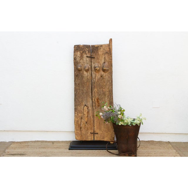 Carved from a single length of hardwood, this door features a motif documented specifically within Dogon granary door...