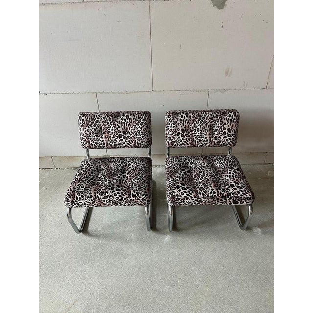 A striking pair of 1970s cantilever lounge chairs, featuring elegant polished chrome tubular frames and newly upholstered...