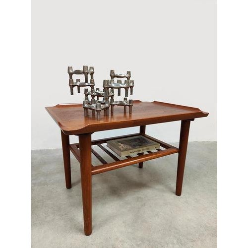This vintage Scandinavian side/coffee table from the 1960s is crafted from warm teak and features a refined, functional...