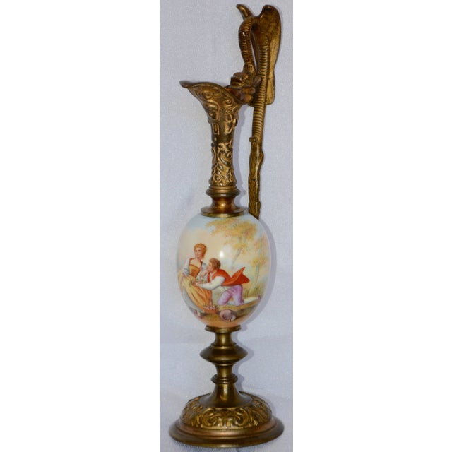 The fine hand-painting on this miniature ewer depicts a gentleman offering flowers to his lady. The painted details are...