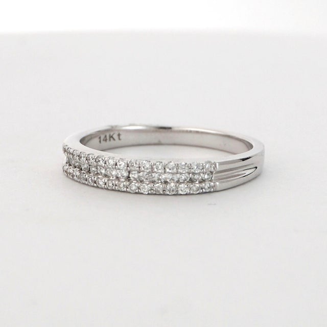 This elegant ring is crafted in 14K gold. It features two rows of sparkling white round-cut diamonds. The diamonds are set...
