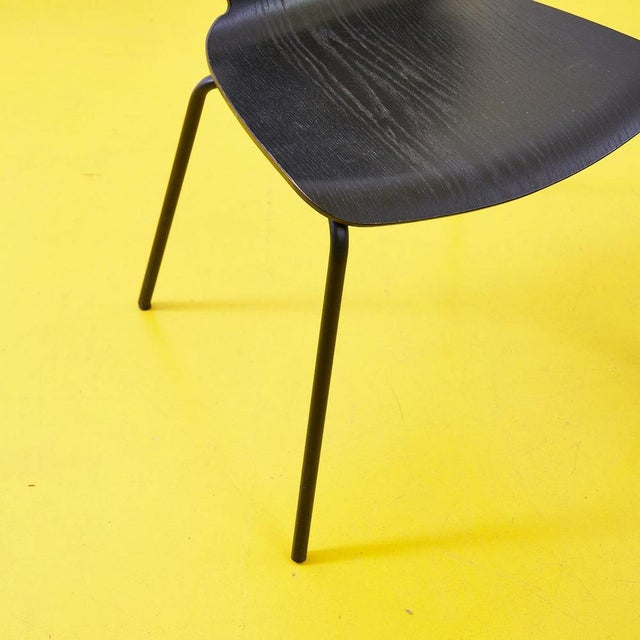 This contemporary chair is a perfect example of minimalist elegance. Crafted from high-quality black wood, it offers ideal...