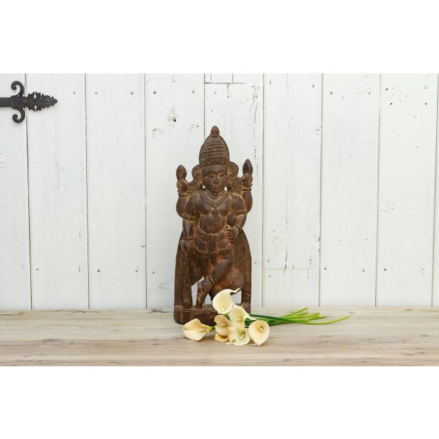 This tall antique wooden statue from India depicts Jaya. Jaya is considered a guardian of Vishnu. The antique Indian...