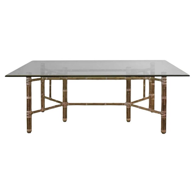 Original dining table Attributed to John and Elinor McGuire for McGuire Furniture. This rectangular dining table showcases...