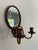 This is a vintage wall mount sorcerer’s mirror with articulating candle sconces. The mirror shows signs of age with light...