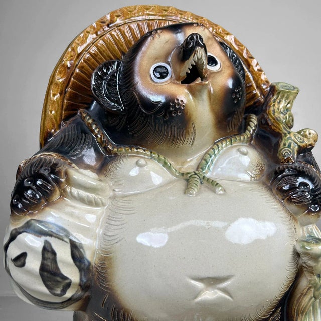 Dimensions: height 46 cm, width 36 cm, depth 26 cm. Cheerful Tanuki statue, crafted in the 1960s from classic Shigaraki...