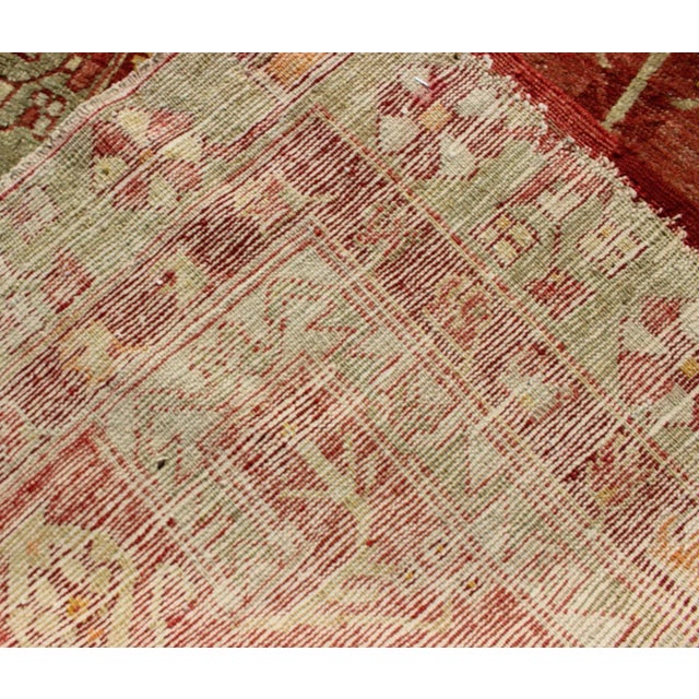 Antique Oushak Rug From Turkey With Directional Tribal Motifs in Soft Rose Red & Green For Sale In Atlanta - Image 6 of 7