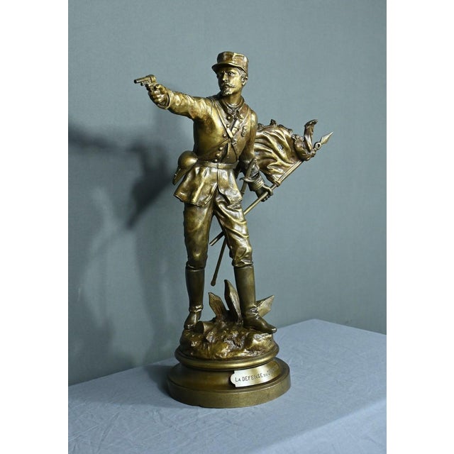 This bronze with medal patina entitled “The Defense of the Flag” signed Charles Anfrie (1833-1905), represents a soldier...
