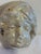 A charming vintage chalkware wall plaque featuring the serene face of a sleeping child. The sculpted relief is highlighted...