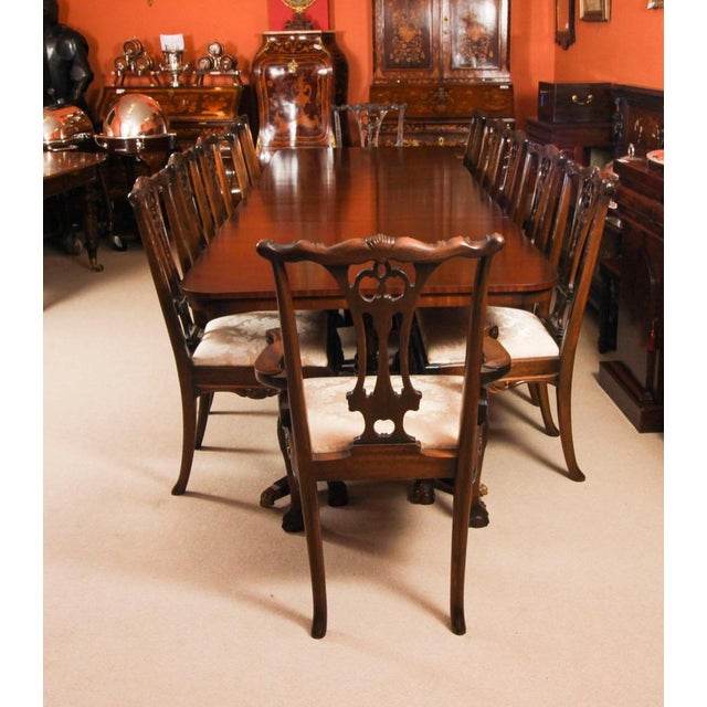 This is a superb large vintage twin pedestal dining table in elegant george iii style, crafted in mahogany with twelve...