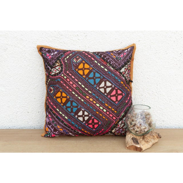 This 16-inch square pillow is a breathtaking fragment of Rajasthani heritage, repurposed from antique Banjara textiles...