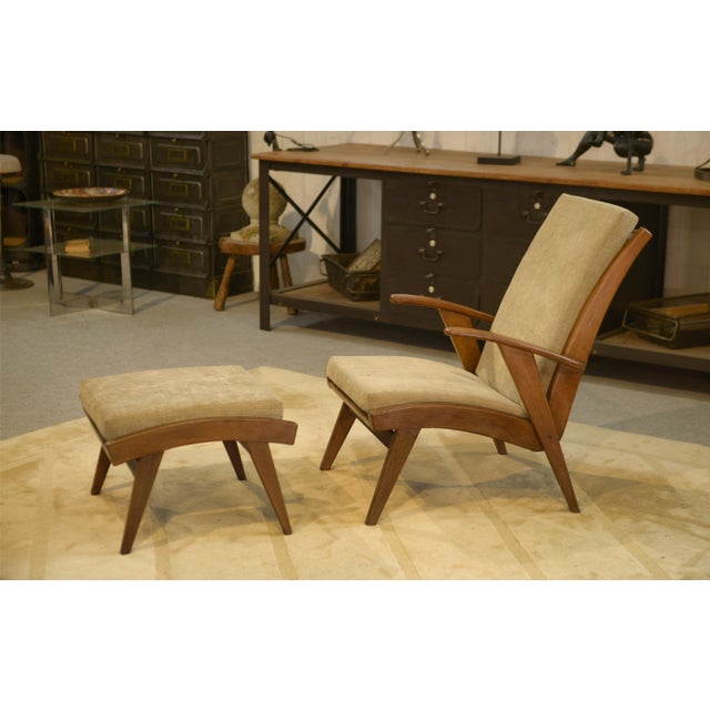 A Scandinavian lounge chair from the 1960s, with low, sloping lines, designed for relaxing. It features a wooden frame...