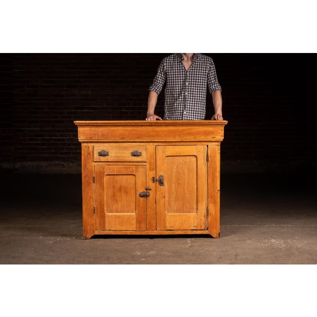 Painted pine dry sink featuring a rectangular open basin above a case fitted with a single drawer over two paneled cabinet...