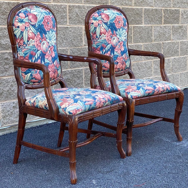 A high quality pair of vintage carved arm chairs with vintage floral upholstery. Imported from Spain.