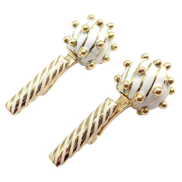 David Webb 18k yellow gold cufflinks feature bold white enamel spheres adorned with polished gold spike accents, creating...