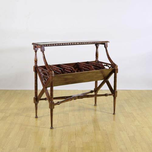 This elegant magazine table, dating back to the early 1900s, is a fine example of regency-style furniture. Crafted from...