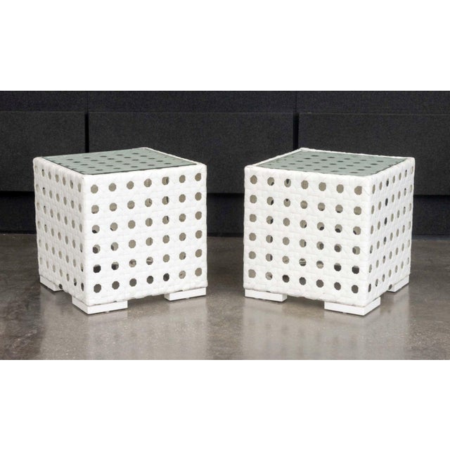 Pair of Skyline Design Glass Top Side Tables, on woven white plastic bases. 25" H x 24.5" W x 24.5" D. Provenance: From a...