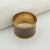 A quietly elegant set of eight vintage napkin rings combining warm brass with a smoky taupe-brown marbled finish. The...