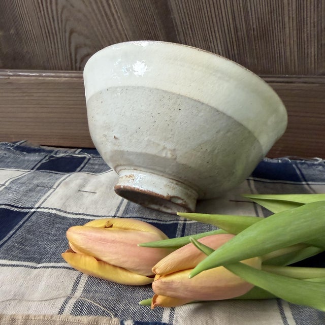 This generous Japanese matcha bowl has an elegant, open shape with a gently flaring rim and a solid, low foot ring....