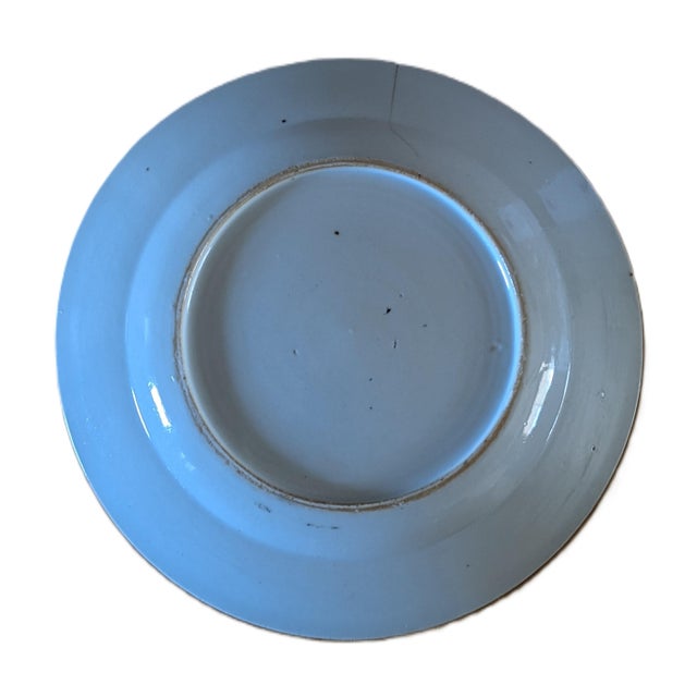 A famille rose plus blue plate with floral and fruit patterns in the center, navy and gilt "star" border/rim with dot...