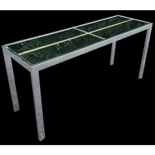 This Vintage Chrome, Brass & Smoked Mirror Console Table is ultra striking and dramatic with a minimalist European design,...