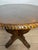 Elegant round side table crafted in richly figured walnut, featuring a sculptural pedestal base with flowing scroll...