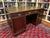An imposing antique English double-sided, three-piece mahogany partners desk with a triple inset, gilt tooled, blind...