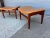 A pair of teak foot stools in new tan leather. As a bonus, the footstools come apart, which makes it very easy to ship...