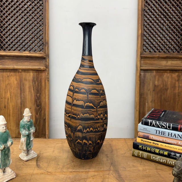 "About This Piece About This Piece Commanding and refined, this vase embodies the elegance of modern artistry. Its...