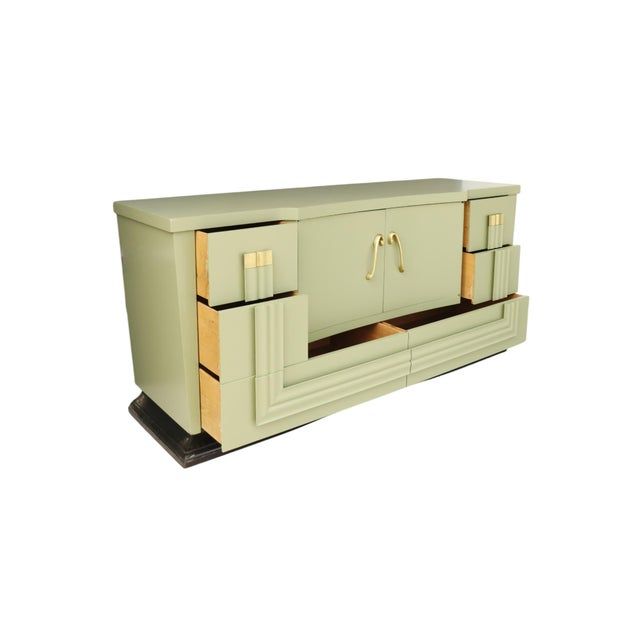A French style mid-century dresser in sage green. The sculptural dresser front consists of four small and two long...