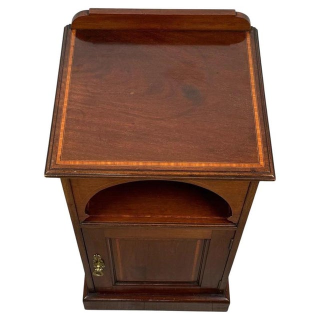 A fine early 20th-century English pot cupboard, beautifully crafted from mahogany and distinguished by its elegant...