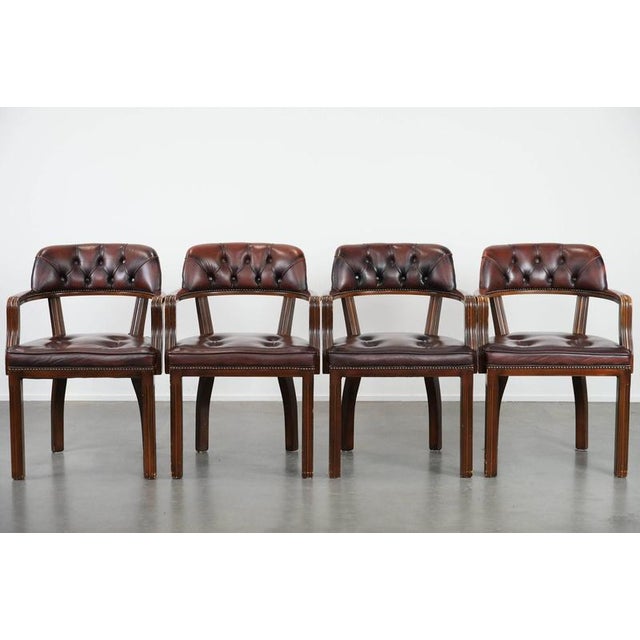 This magnificent set of four dark brown Chesterfield chairs has a classic English look. They are made of cowhide and...