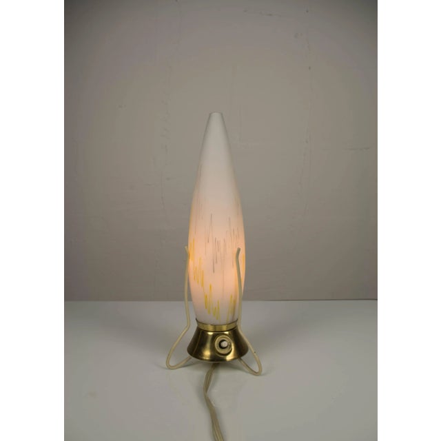 Made in Czechoslovakia in 1950s in so called Brussell style. The lamp is made of colored milk glass and has a brass...