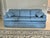 Vintage three cushion skirted sofa featuring rolled arms and blue floral damask upholstery. Comes with Two arm covers and...