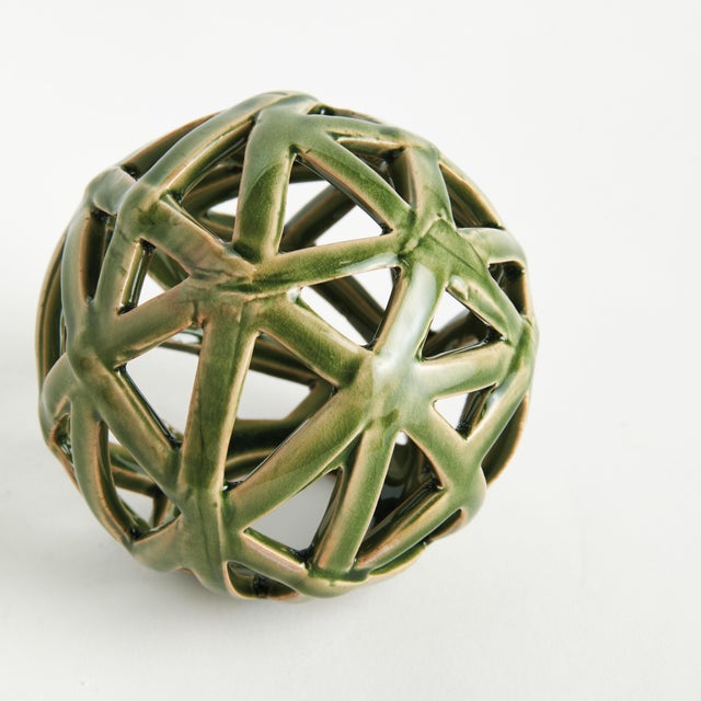 This contemporary little orb is made of thin ceramic strips giving it an open and airy feel. The dynamic, reactive glaze...