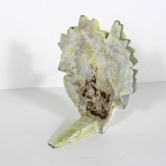 Vintage teacup with yellow and mauve purple flowers with green leaves door stop made from cast iron. Very heavy with some...