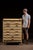Painted wooden cabinet featuring seven full-width drawers housed within a beadboard case with shaped gallery back and a...