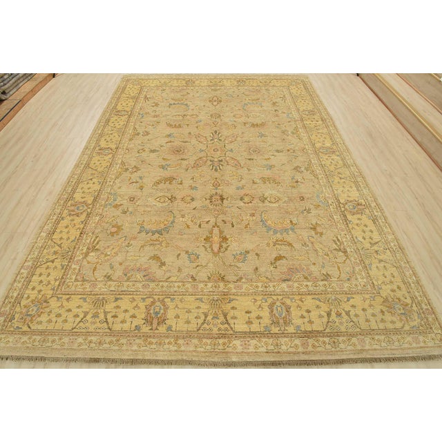 This modern traditional Ziegler rug is hand-knotted with an all-wool pile on a cotton foundation. This rug is new and in...