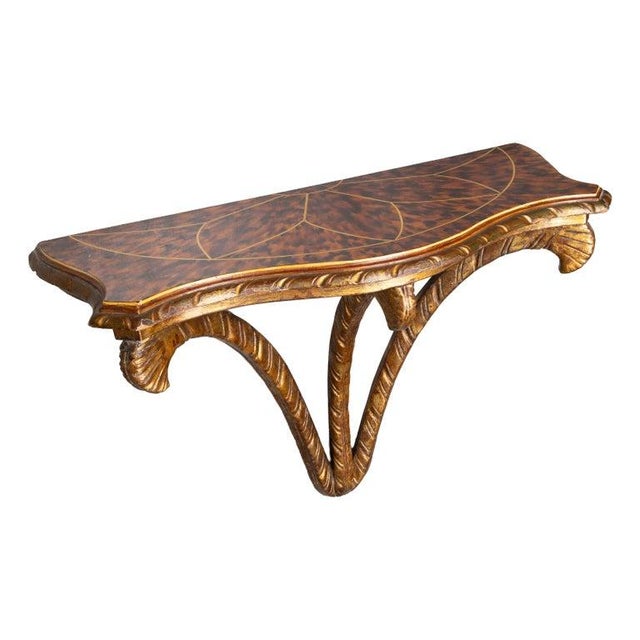 This is an elegant decorative wall bracket featuring a shaped faux tortoiseshell top with geometric brass string inlay,...