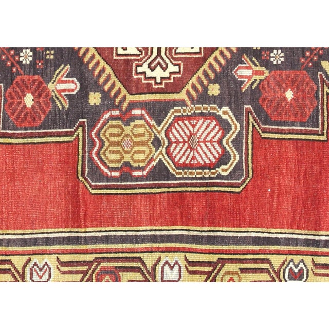 A vintage Turkish Oushak measuring 5'1" x 11'10", hand-woven with wool on wool foundation. This piece displays the...