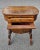 A 19th Century Victorian Walnut and Marquetry Burl sewing table with plenty 9f storage and on Wheels. Measures 24.25" in...