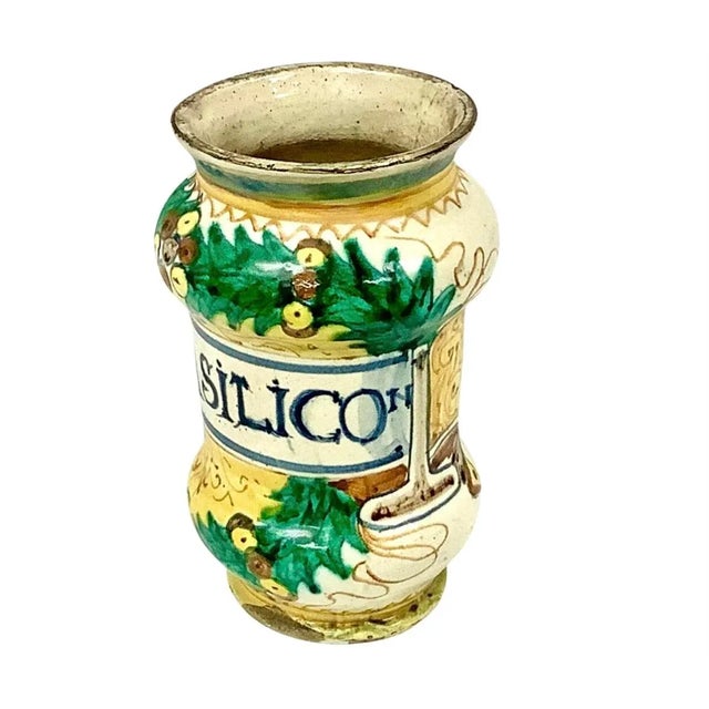 17th Century Italian Faience ceramic apothecary jar. Bright colors of yellow, green and dark blue on cream background. In...
