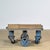 A 1960s industrial coffee table featuring a combination of a heavy wooden top and a robust metal base. The weathered wood...