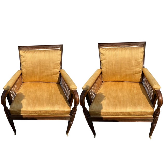 Elevate your interior with this exceptional pair of Regency-style mahogany and cane bergère armchairs Timeless Design &...