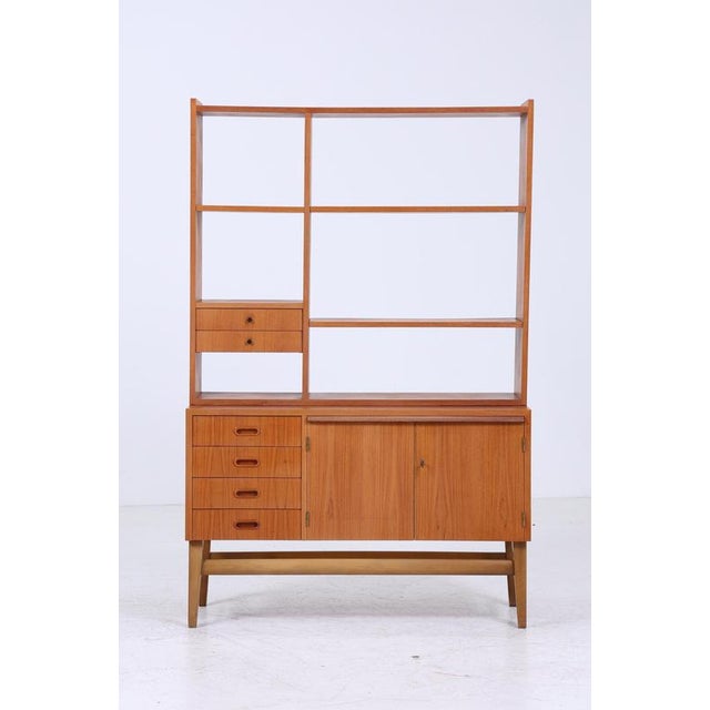 Beautiful vintage teak shelf from the 60s FEATURES * Timeless design * 4 shelves * Material: Teak * Pull-out writing...